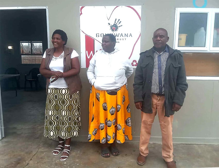 Three Namibians in front of a building